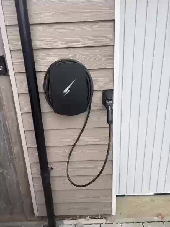 EV charger on timber-effect cladding
