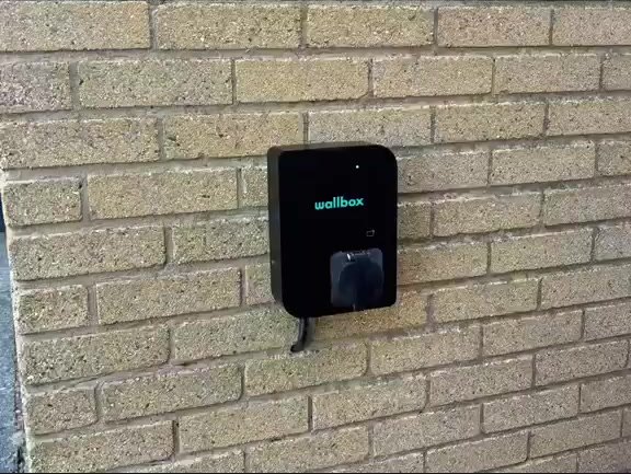 EV charger fitted to a brick wall