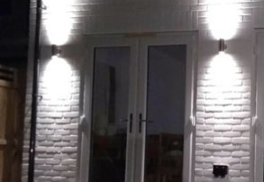 Outdoor up-and-down wall lights either side of patio doors